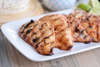 Three pieces of chipotle grilled chicken on white platter