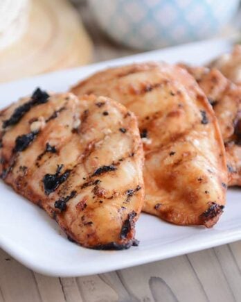 Three pieces of chipotle grilled chicken on white platter