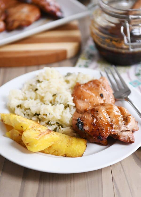 Grilled hawaiian chicken on plate with grilled pineapple and rice.