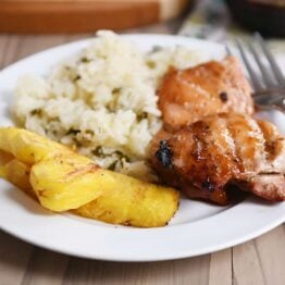 Grilled hawaiian chicken on plate with grilled pineapple and rice.