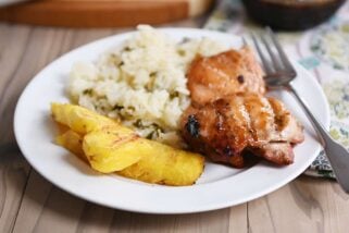 Grilled hawaiian chicken on plate with grilled pineapple and rice.