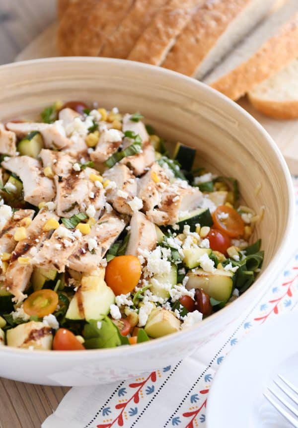 Grilled chicken orzo salad in white serving bowl.