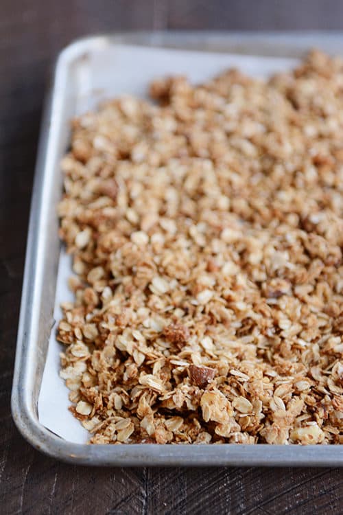 A cookie sheet of baked almond granola. 