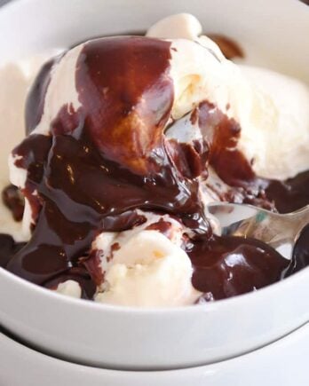 Vanilla ice cream in white bowl with 5-minute hot fudge sauce on top.