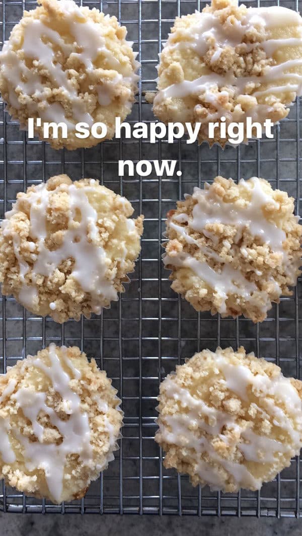 Top view of streusel and frosting topped lemon muffins on a cooling rack.