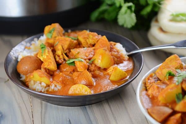 A bowl of Instant Pot Indian Butter Chicken and rice.