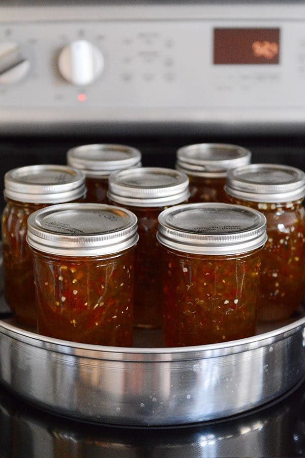 Seven jars of jalapeno jelly in a steam canner. 