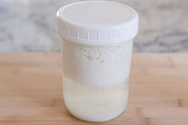 A glass mason jar with kefir milk.