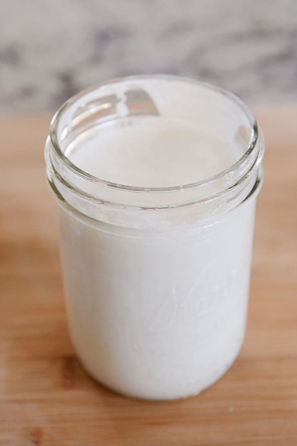 A mason jar full of creamy kefir milk.