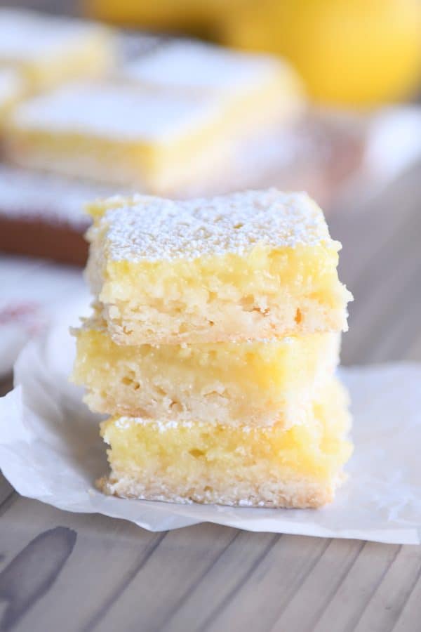 Three lemon bars stacked on top of each other.