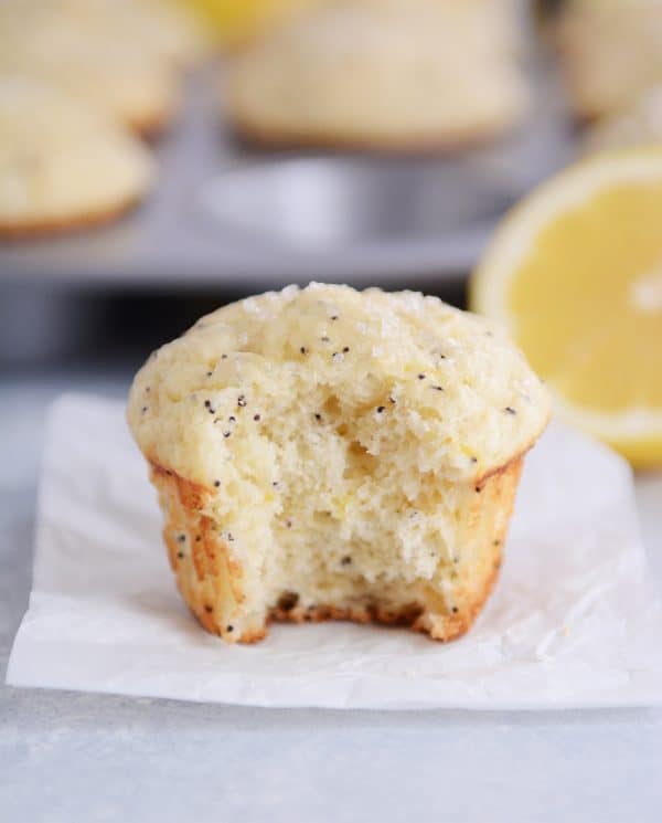 A lemon poppy seed muffin with a bite taken out. 