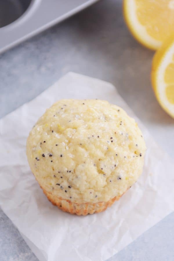 a lemon poppy seed muffin on a piece of parchment