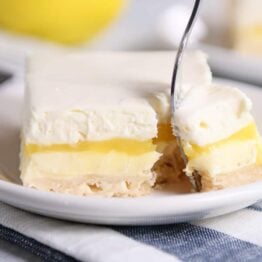 Lemon truffle shortbread bar on white plate.