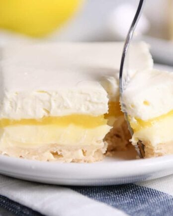 Lemon truffle shortbread bar on white plate.