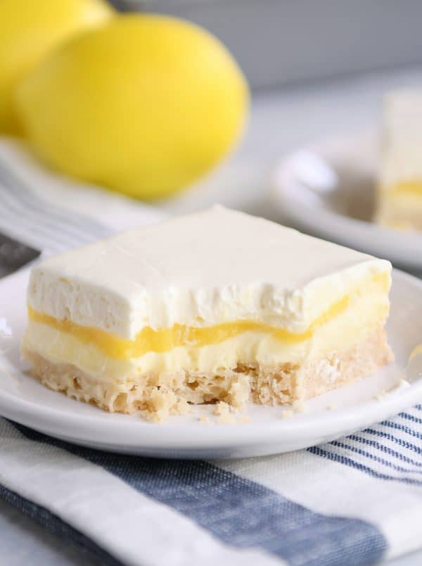 Lemon truffle shortbread bar on white plate. 