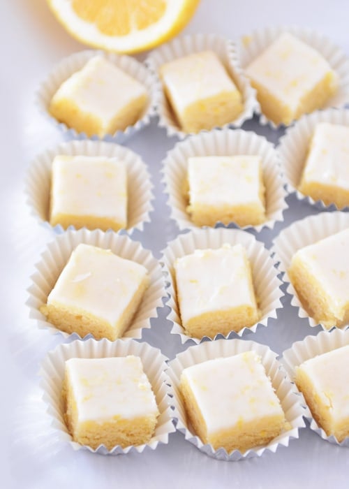 Top view of iced lemon brownies in small muffin cups. 