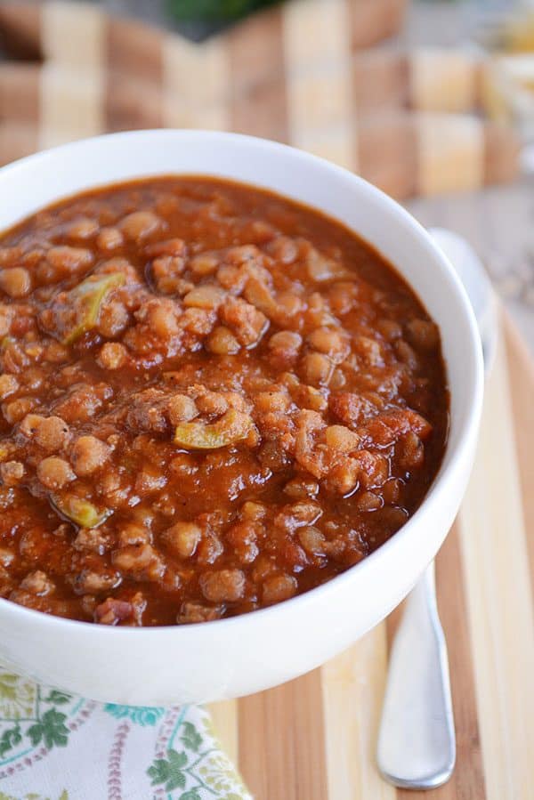 Top view of a white bowl full of lentil beef chili. 