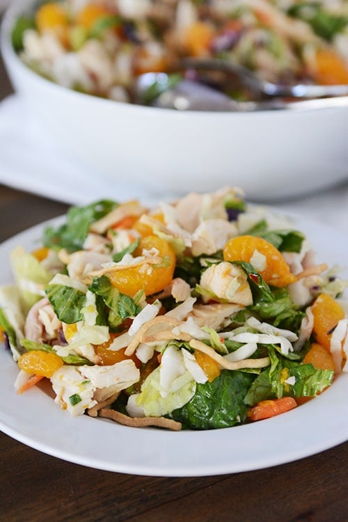 A white plate of mandarin orange chicken salad. 