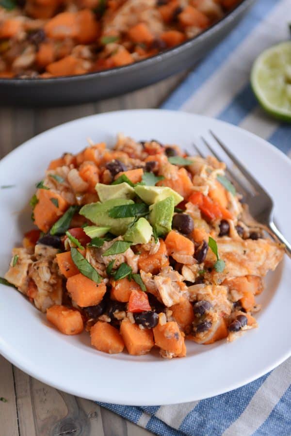 A white plate of Cheesy Mexican Sweet Potato mixture. 