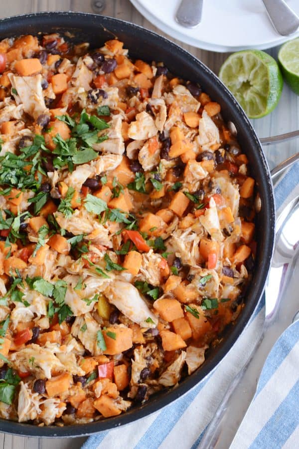 A skillet of cheesy sweet potato and black bean meal. 