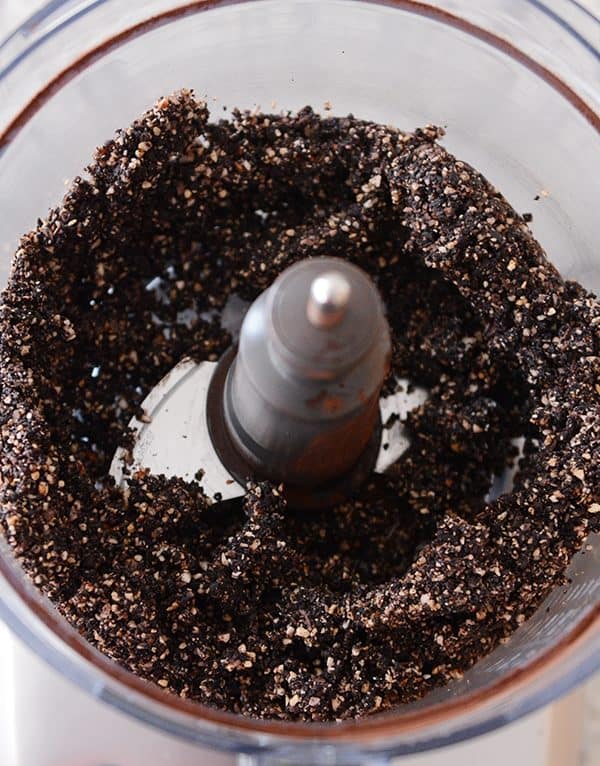 A food processor of Healthy Dark Chocolate Almond Joy Bite mixture. 