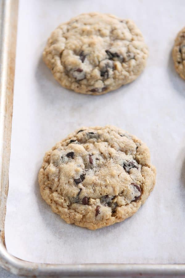 Oatmeal chocolate chip cookie on baking pan.