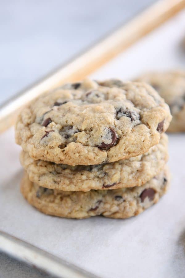 Stack of oatmeal chocolate chip cookies on baking pan.