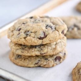 Stack of oatmeal chocolate chip cookies on baking pan.