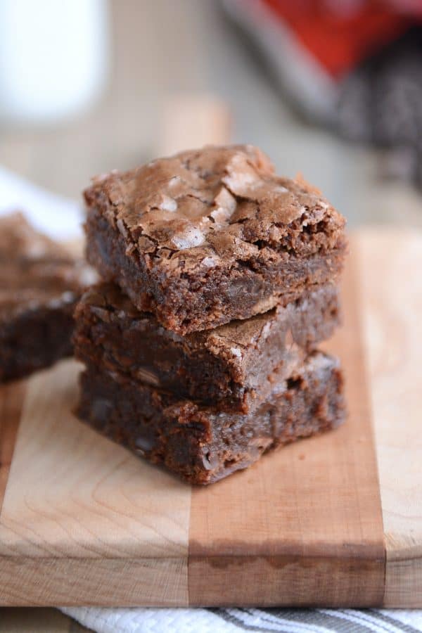 Three chocolate brownies stacked on top of each other.