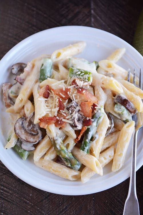 Top view of a plate of creamy asparagus pasta.