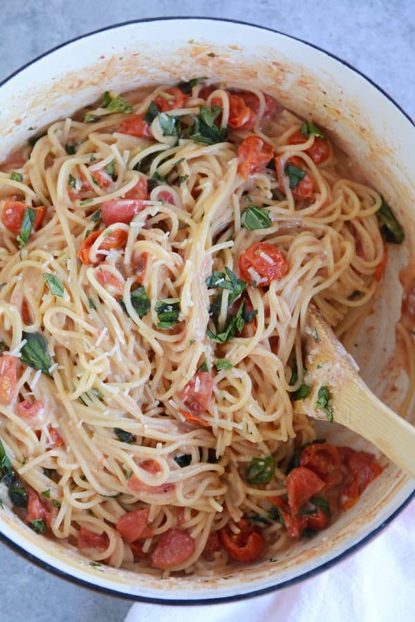 One pot creamy tomato basil pasta in ceramic pot.