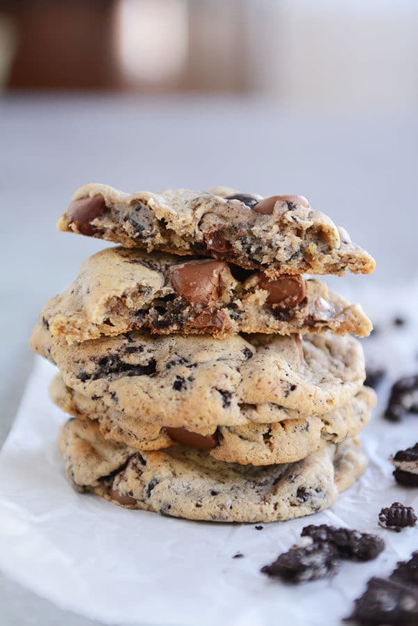 A stack of Oreo chocolate chip cookies with the top cookie split in half.