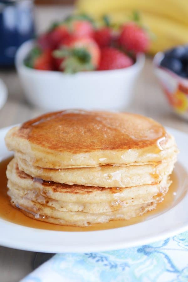 A stack of pancakes covered in syrup. 