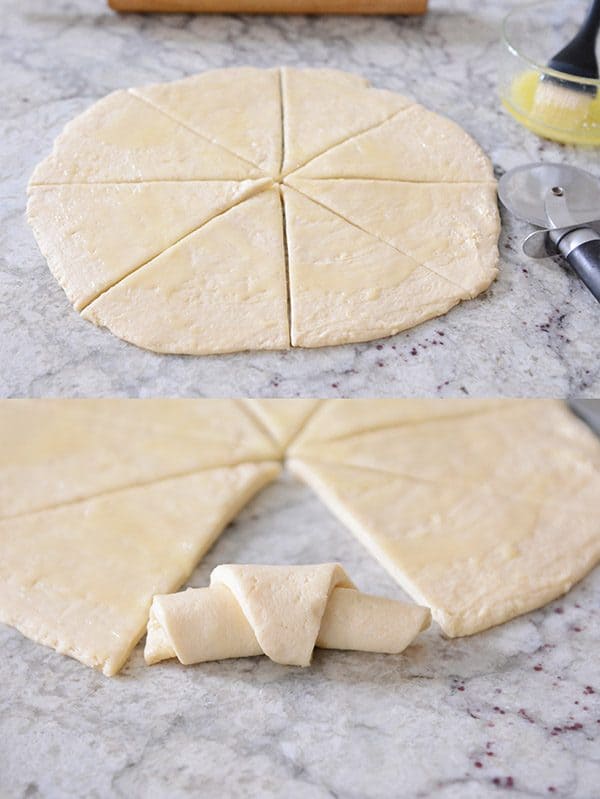 Roll dough flattened out and cut into wedges ready to be rolled into crescent shapes.