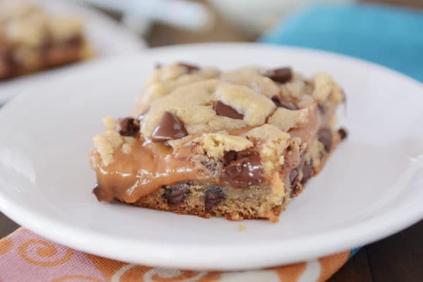 Peanut butter caramel cookie bar on a white plate.