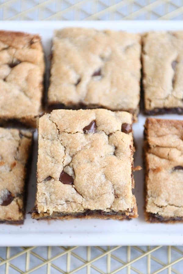 Top down view of white tray of peanut butter chocolate chip bars.