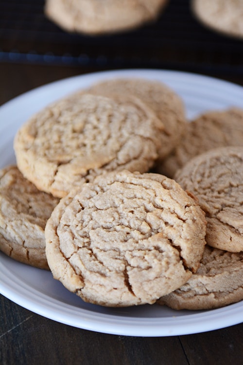 A white plate full of peanut butter cookies. 