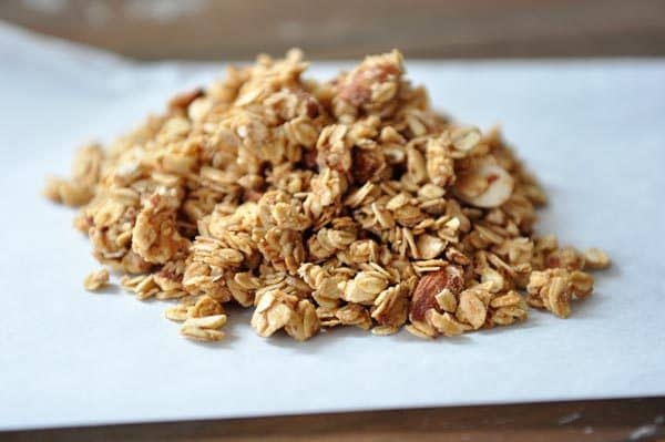 Peanut butter granola in a little pile on a piece of parchment. 