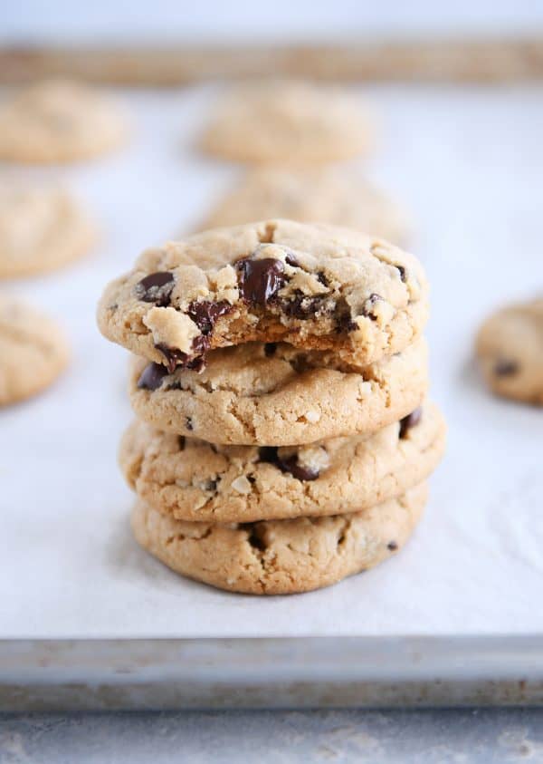 Stack of peanut butter oatmeal chocolate cookie on parchment paper. 