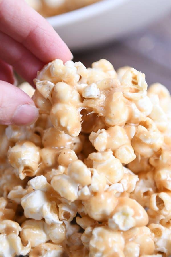 Pulling off a piece of peanut butter caramel popcorn.