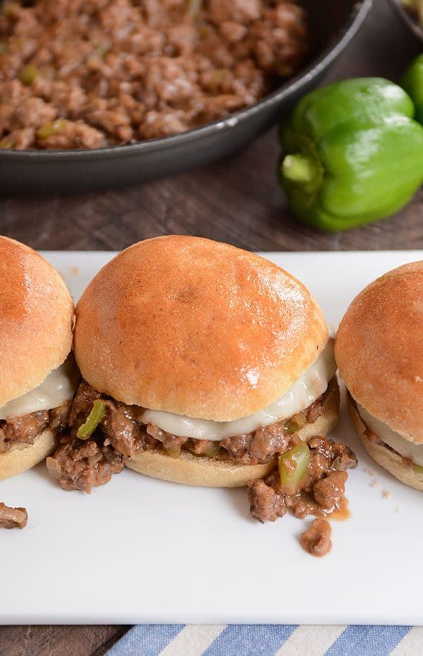 Top view of golden brown buns filled with a philly cheesesteak sloppy joe mixture.