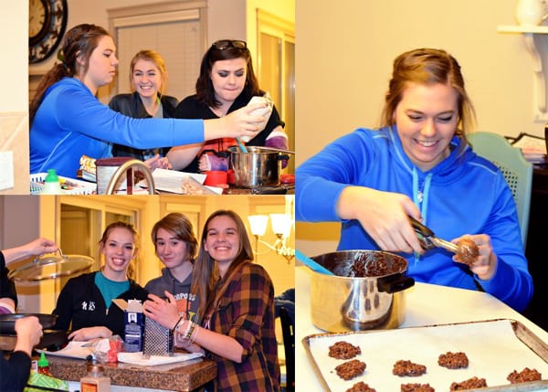 Teenage girls making cookies together. 
