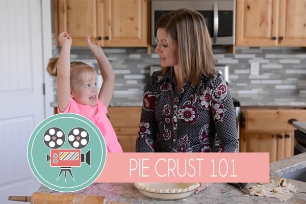 A mom and little girl cooking in the kitchen together.