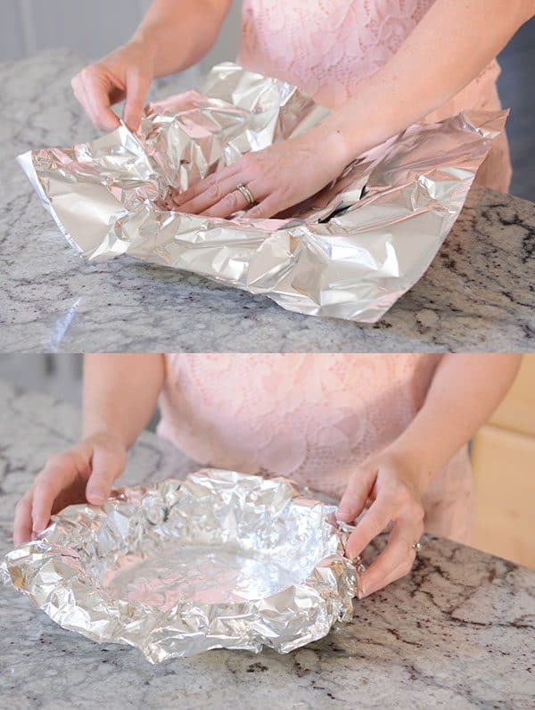 Tinfoil getting put into a pie dish.