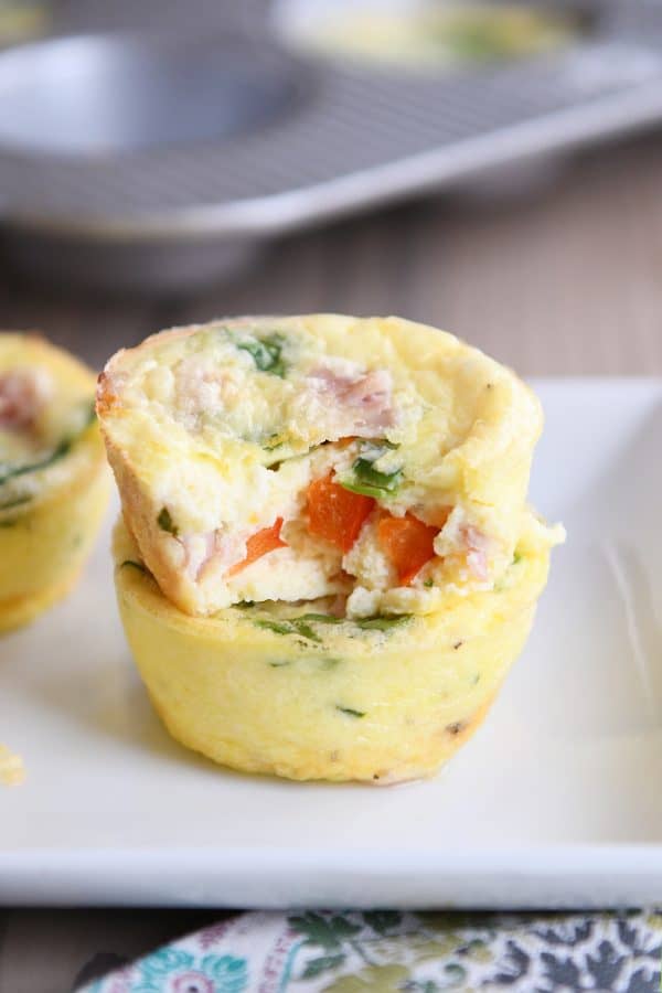 Bite out of healthy egg and veggie muffin.