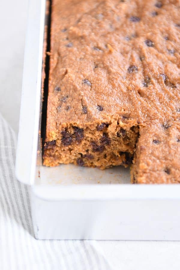 Cut out piece of pumpkin chocolate chip snack cake in metal pan.