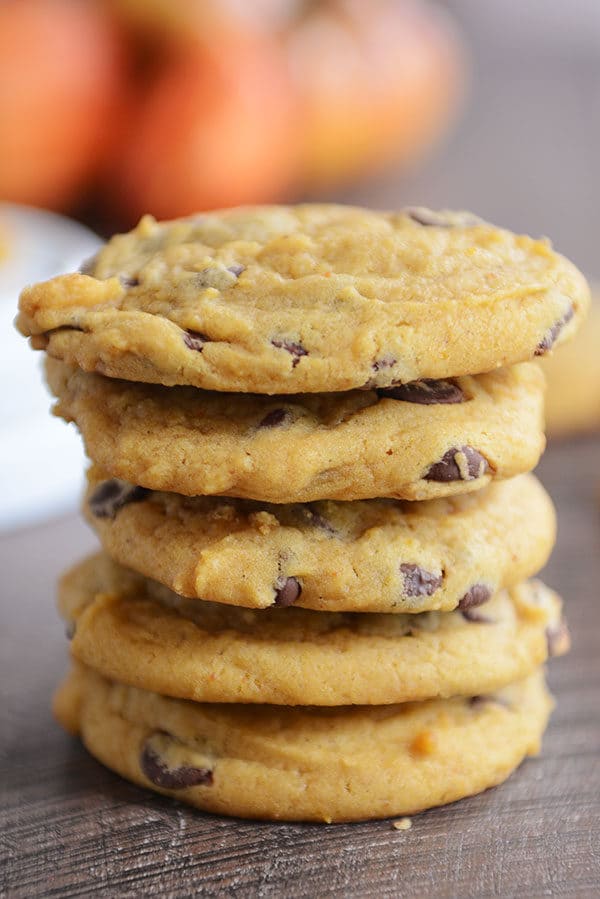 Five pumpkin chocolate chip cookies stacked on top of each other.
