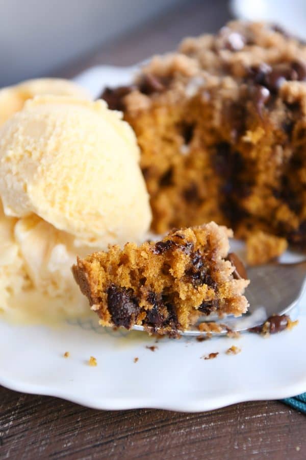 Pumpkin chocolate chip streusel cake with scoop of vanilla ice cream.