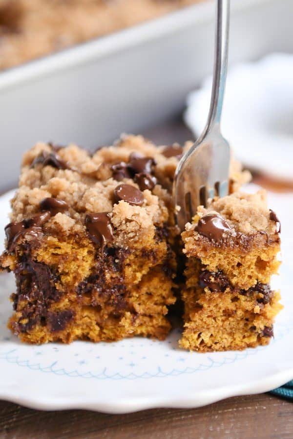 Fork taking a piece out of pumpkin chocolate chip streusel cake.