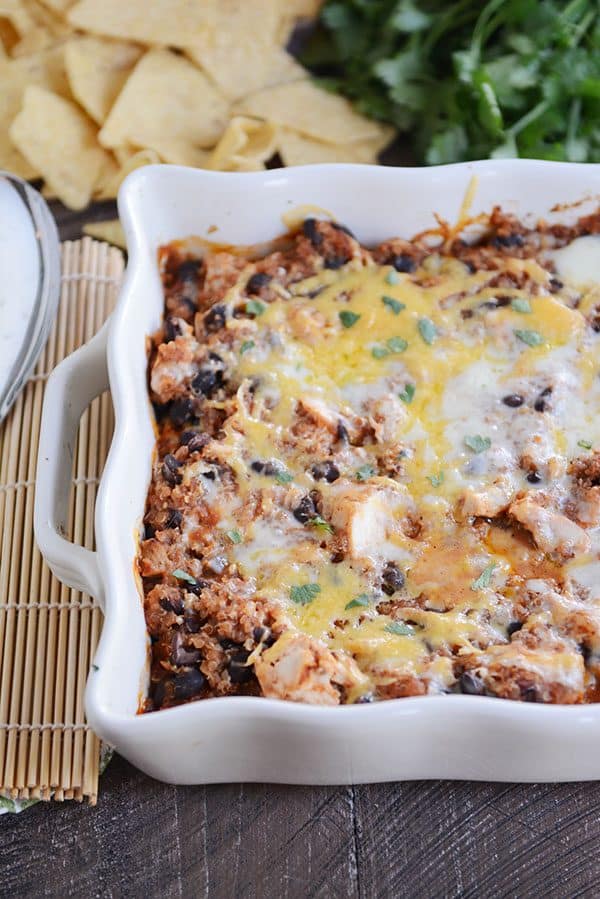 A white casserole dish full of cheesy black bean quinoa bake.